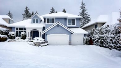 Snow storm in Northwest United States with residential home and dark sky in background