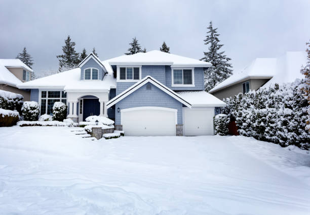 Snow storm in Northwest United States with residential home and dark sky in background